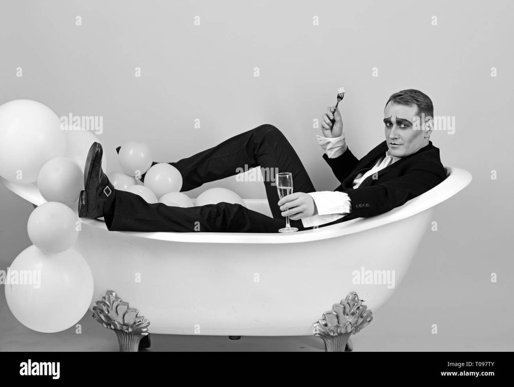 i-am-celebrating-mime-actor-enjoy-bathing-in-bath-tub-bathing-and-relaxing-mime-man-has-celebration-party-with-food-and-drink-comedian-actor-T097TY